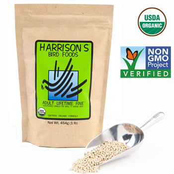 A bag of Harrison's Bird Foods labeled as 'Adult Lifetime Fine' with a green and orange GMO Project verification icon, and a spoonful of the granulated bird food in front.